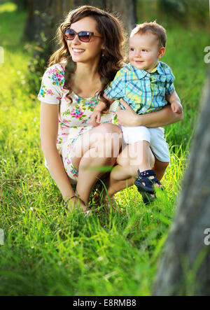Smiling mom pretty brunette woman and her little cute daughter in the