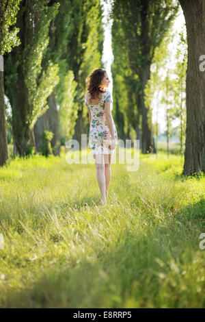 Shapely pregnant woman in the green park Stock Photo