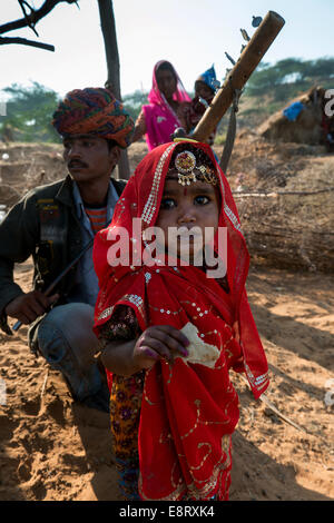 A baby girl with his parent in traditional Indian dresses.Pushkar, Rajasthan,India. Stock Photo