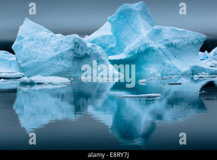 A deep blue iceberg and it's reflection in Narsarsuaq, Greenland Stock Photo