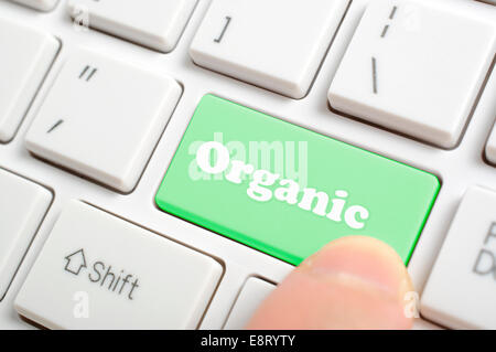 Pressing green organic key on keyboard Stock Photo