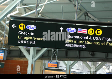 Check in,international and USA flight sign inside YVR airport. Stock Photo