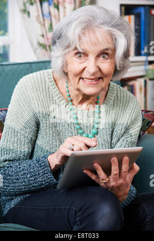 Senior Woman Using Digital Tablet At Home Stock Photo