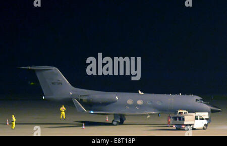 FILE - An archive picture, dated 09.10.2014, shows a Gulfstream III from Gulfstream Aerospace surrounded by four people in protective gear at the airport Halle/Leipzig in Schkeuditz, Germany. The plane was converted into a transporter for highly infective patients and carried an Ebola-infected man from Africa to Leipzig. The Ebola patient in Leipzig is dead. The St. Georg clinic reports the man died in the night on 14 October 2014. Photo: Peter Endig/dpa ATTENTION: Best-possible quality Stock Photo