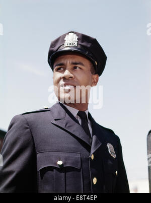 1960s PORTRAIT AFRICAN AMERICAN POLICE OFFICER POLICEMAN Stock Photo