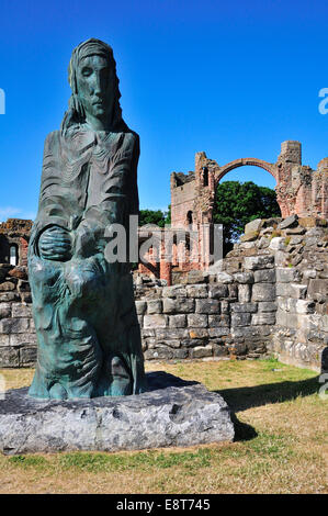 Statue of Saint Cuthbert of Lindisfarne, ruins of the Benedictine monastery of Lindisfarne, Lindisfarne, Northumbria, England Stock Photo