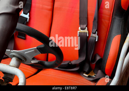 An off road red rusty buggie parked on a karting circuit. Seat detail Stock Photo