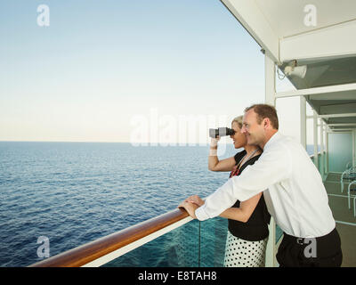 Caucasian couple admiring view from boat deck
