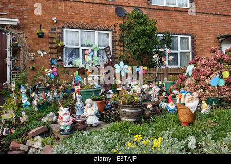 A collection of garden gnomes outside a terraced house, Worcester, UK Stock Photo