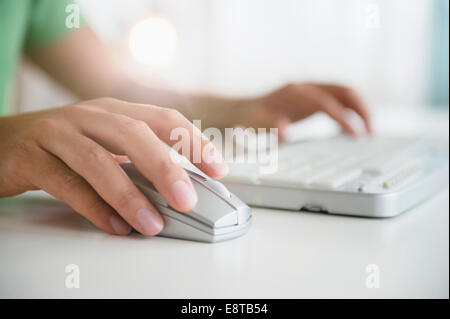 Mixed race man using wireless mouse and keyboard Stock Photo