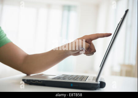 Mixed race man pointing to laptop screen