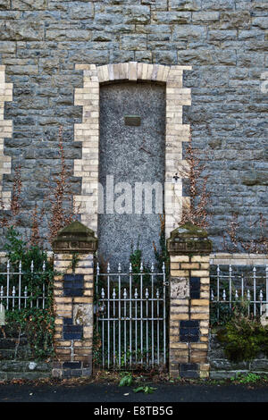 Knighton, Powys, Wales, UK. A sinister grey stone Victorian house with the front door walled up or bricked up Stock Photo
