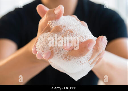 Close up of mixed race man washing his hands Stock Photo