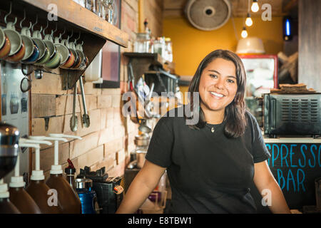 Hispanic woman working in coffee shop