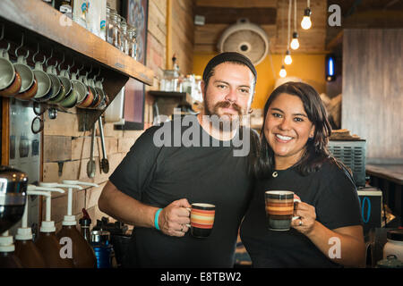 Hispanic couple working in coffee shop Stock Photo