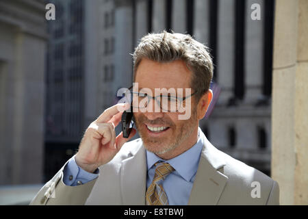 Caucasian businessman talking on cell phone in city, New York City, New York, United States Stock Photo