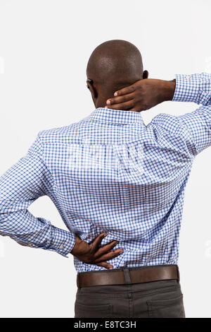 Black man rubbing aching back and neck Stock Photo