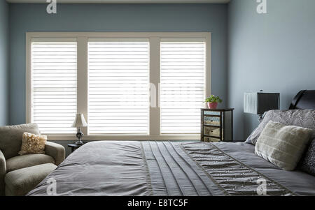 Armchair, bed and dresser in modern bedroom Stock Photo