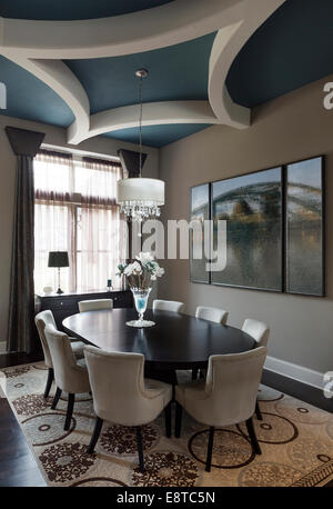 Table and chairs with paintings in dining room Stock Photo