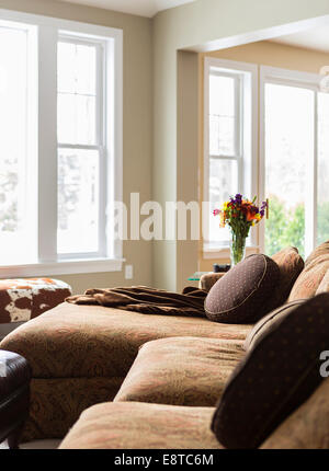 Pillows and throw blankets on sofa in living room Stock Photo