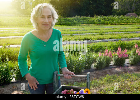 Older Caucasian woman smiling on farm Stock Photo