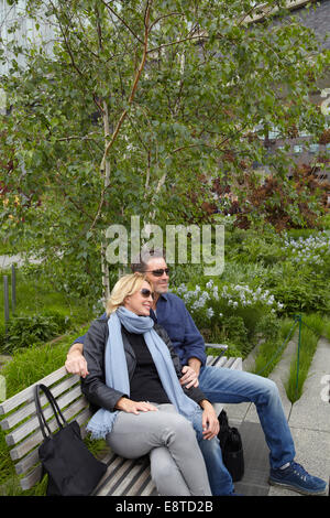 Caucasian couple relaxing on bench in park Stock Photo