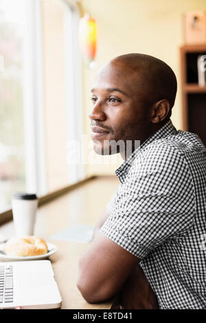 Black man relaxing in coffee shop Stock Photo