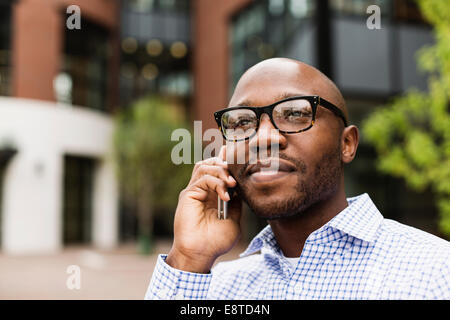 Black man talking on cell phone in city Stock Photo