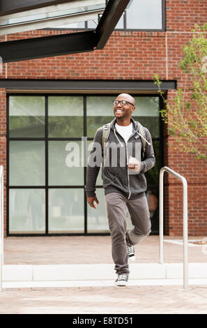 Black man walking in city Stock Photo