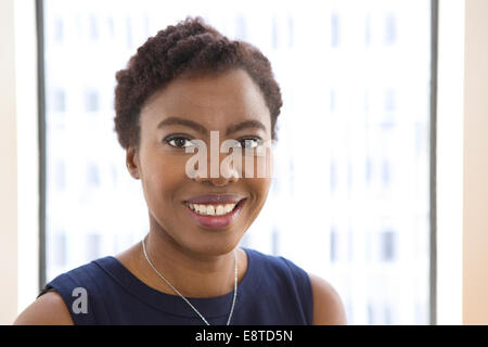 African American businesswoman smiling in office Stock Photo - Alamy