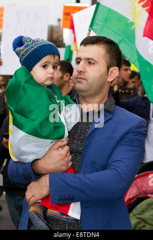 Liverpool, UK. 14th Oct, 2014. Father with Child one of several Protesters marching through Liverpool city centre to demonstrate against terrorist group ISIS. Around 300 protesters marched along Church Street, Bold Street and Renshaw Street before picketing outside Lime St Station. Sabiha Soylu took part in the march because she feels more needs to be done to help Kurdish fighters - who are battling with heavily-armed ISIS mililtants. Credit:  Mar Photographics/Alamy Live News Stock Photo