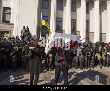 Oct. 14, 2014 - The former head of the anti-corruption committee Tatyana Chornovil stands between the radicals and the police to prevent a collision. -- ''Right sector'' and ''Freedom'' disown provocations at the Verkhovna Rada. About 30 protesters started throwing soldiers of the National Guard cobblestones at the building of the Verkhovna Rada. The protesters demanded the ban of the Communist Party and the recognition of the Ukrainian Insurgent Army belligerent in World War II. © Igor Golovniov/ZUMA Wire/Alamy Live News Stock Photo