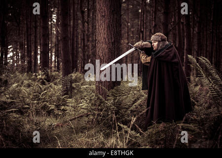 Deep in a forest a Warrior stands ready. Stock Photo