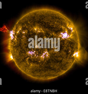 Caption: A burst of solar material leaps off the left side of the sun in what’s known as a prominence eruption. This image combines three images from NASA’s Solar Dynamics Observatory captured on May 3, 2013, at 1:45 pm EDT, just as an M-class solar flare Stock Photo