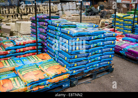 Piles of bags of garden compost branded for different purposes Stock Photo