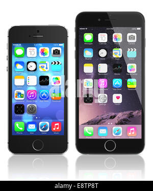 Apple Space Gray iPhone 6 and iPhone 5s showing the home screen with iOS 8 and ios 7. Stock Photo