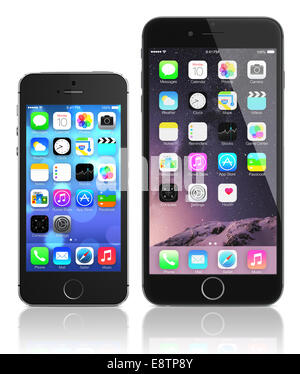 Apple Space Gray iPhone 6 Plus and iPhone 5s showing the home screen with iOS 8 and iOS 7. Stock Photo
