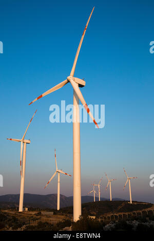 Wind energy turbines are on the mountain and produce cleanest electric energy vertical Stock Photo