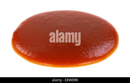 A round blob of red taco sauce on a white background. Stock Photo