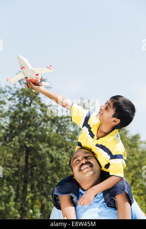 1 Indian Kid Flying Aeroplane with Father Stock Photo