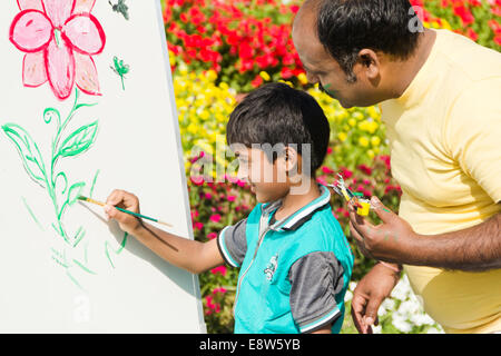 1 Indian man Guidance kid  painting Stock Photo