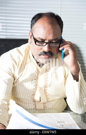 1 Indian Man Reading Newspaper Stock Photo