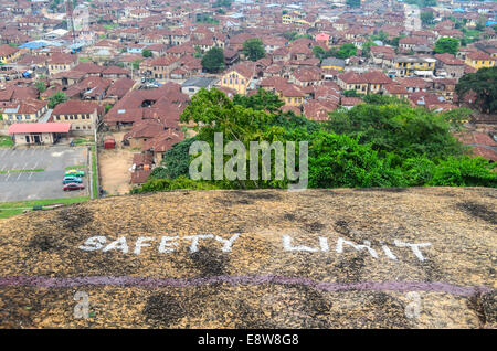 'Safety limit' marking and aerial view of the city of Abeokuta, Nigeria, with rusty houses, taken from Olumo rock Stock Photo