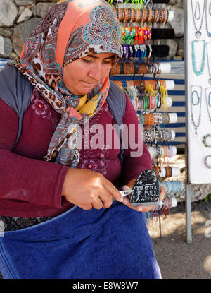 Woman carving a stone, ancient city of Tlos in the Xanthos Valley, Muğla Province, Lycia, Aegean, Turkey Stock Photo