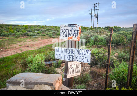 Signs of a private property in Afrikaans on a fence in South Africa Stock Photo