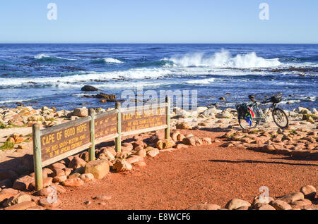 Sign of the Cape of Good Hope, at the southwesternmost tip of Africa, and a touring bicycle in front of the waves Stock Photo