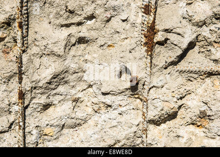 Texture of decomposed armored concrete structure with rusty iron rods Stock Photo