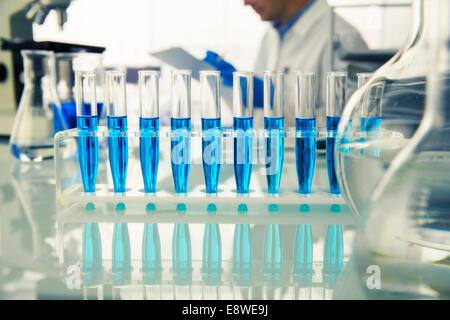 Rack of test tubes with solution on counter in lab Stock Photo