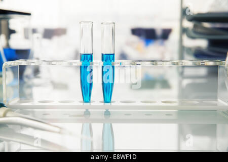 Rack of test tubes with solution on counter in lab Stock Photo