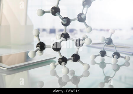 Molecular model and digital tablet on counter in lab Stock Photo